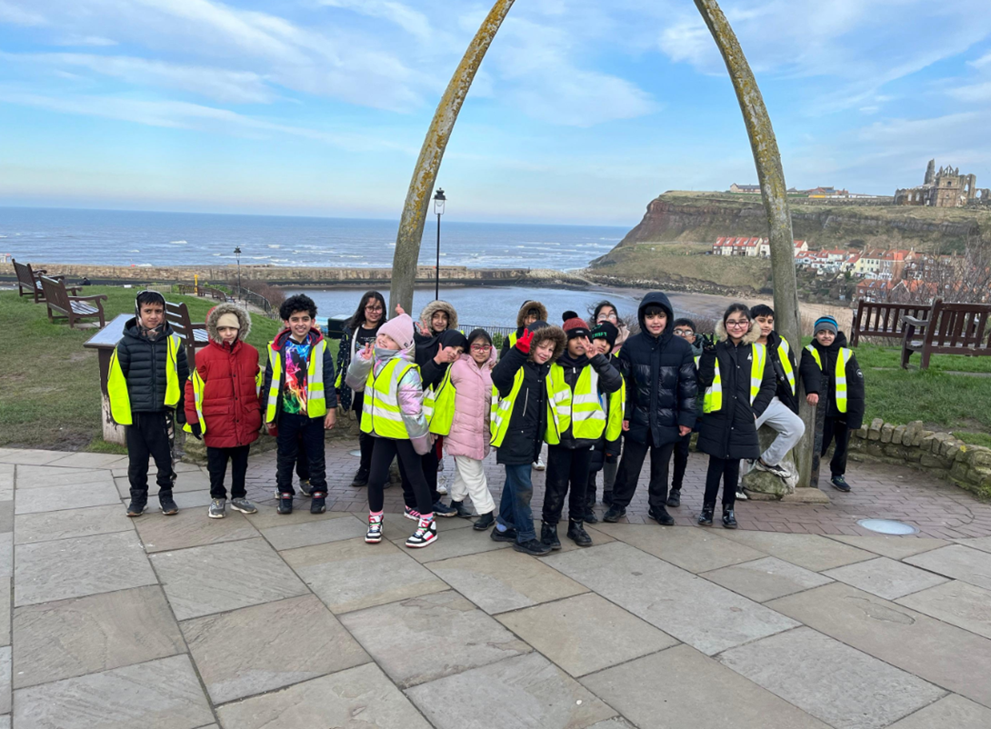 A group of children in front of the Whitby whale bones.